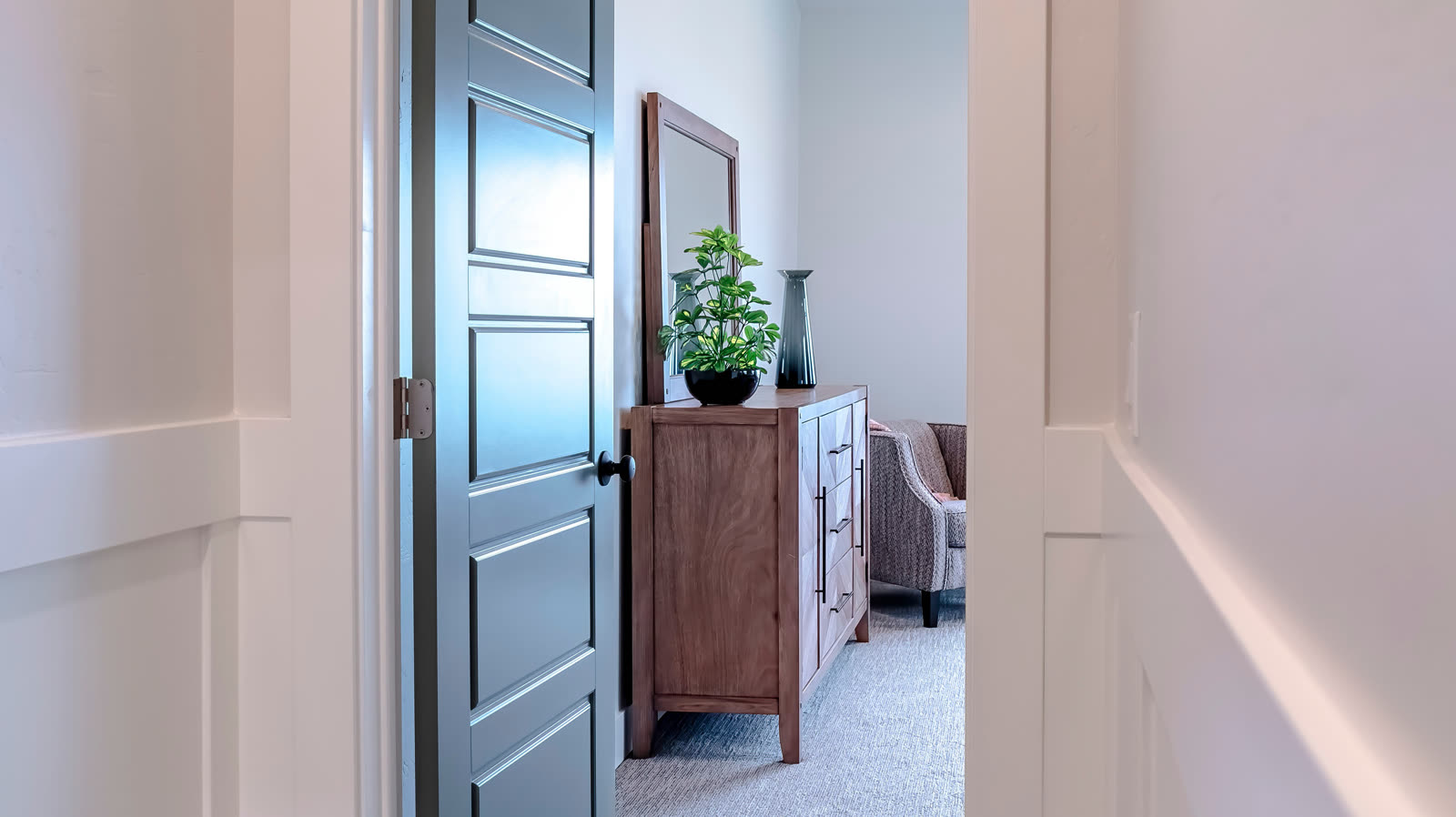 Refinished interior door and trim in a furnished hallway